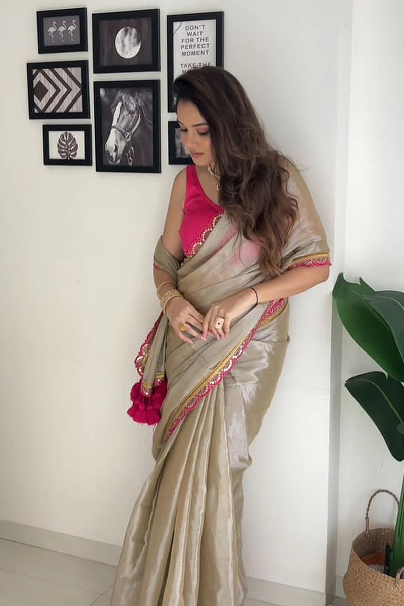 Fairytale Beige Mul Mul Tissue Silk Saree With Handmade Tussels