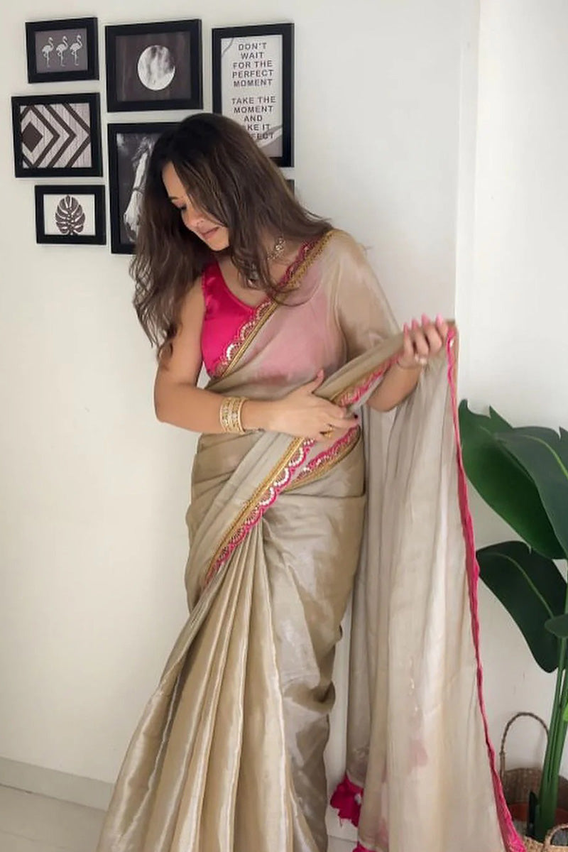 Fairytale Beige Mul Mul Tissue Silk Saree With Handmade Tussels